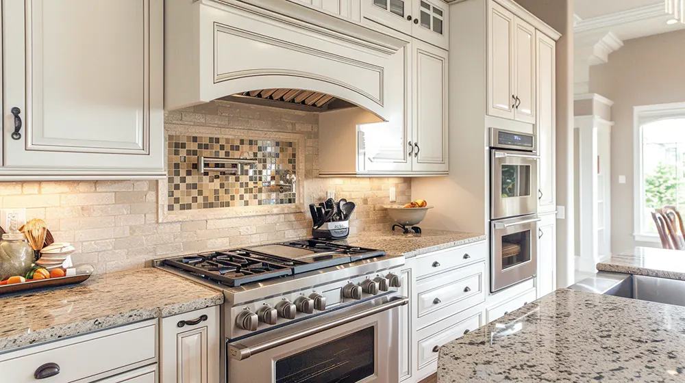 a fancy kitchen backsplash with white cabinets