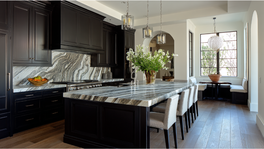 An elegant kitchen featuring dark shaker cabinets, a striking marble island and backsplash, and upscale lighting.